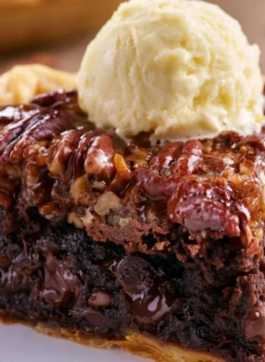 Delicious Brownie Pecan Pie served on a dessert plate with pecans on top