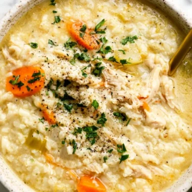 Bowl of homemade Chicken and Rice Soup with fresh herbs and vegetables