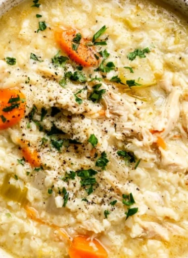Bowl of homemade Chicken and Rice Soup with fresh herbs and vegetables