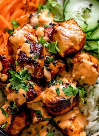 Delicious cozy Bang Bang salmon bowl with fresh vegetables and sauce