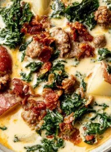 Delicious creamy Tuscany soup served in a bowl with fresh herbs and bread