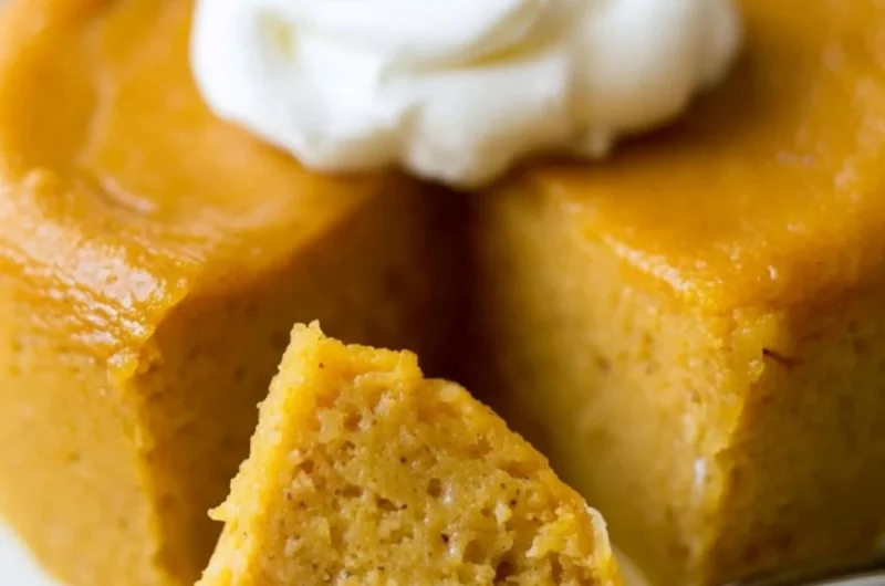 Delicious crustless pumpkin pie pudding served in a bowl with whipped cream.