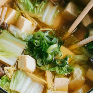 A bowl of delicious Napa Cabbage Tofu Soup filled with fresh greens and tofu.