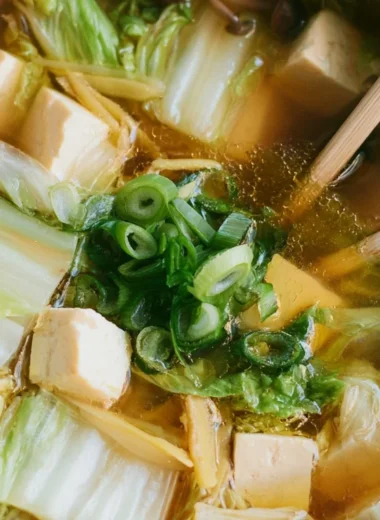 A bowl of delicious Napa Cabbage Tofu Soup filled with fresh greens and tofu.