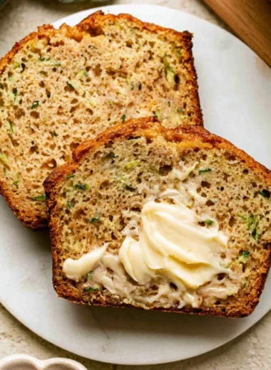 Baked Greek yogurt zucchini bread sliced on a wooden board