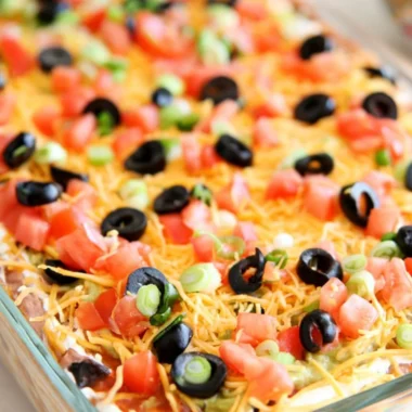 Ultimate seven layer bean dip with colorful layers of beans, cheese, and toppings