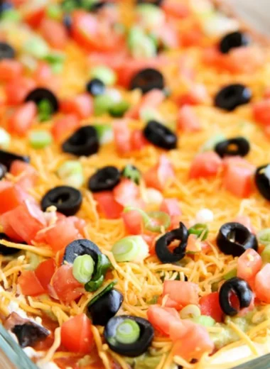Ultimate seven layer bean dip with colorful layers of beans, cheese, and toppings