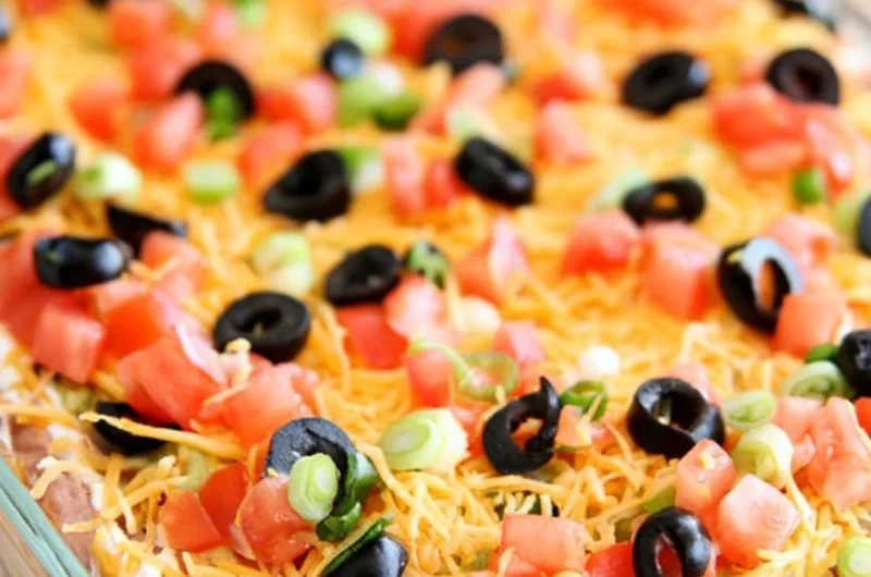 Ultimate seven layer bean dip with colorful layers of beans, cheese, and toppings