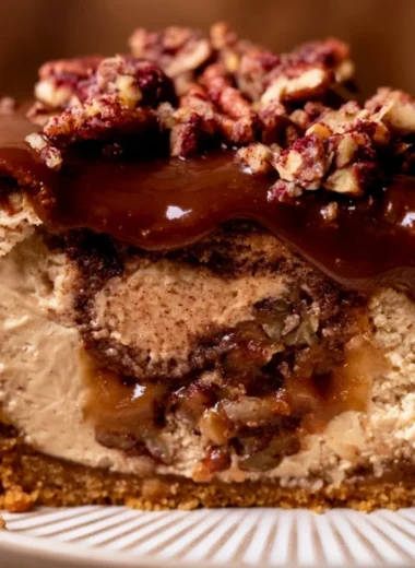 Delicious pecan pie cheesecake topped with whipped cream