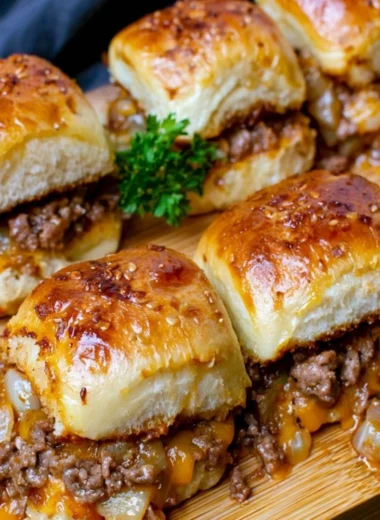Cheeseburger sliders with Hawaiian rolls on a serving platter