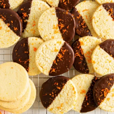 Chocolate dipped orange shortbread cookies on a plate