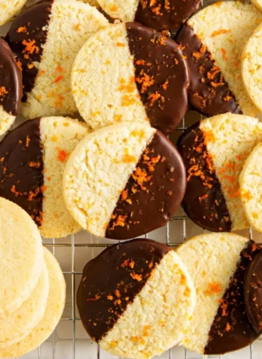 Chocolate dipped orange shortbread cookies on a plate