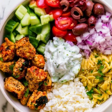 High-protein chicken gyro bowls with fresh vegetables and tzatziki sauce.