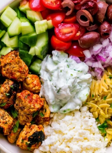High-protein chicken gyro bowls with fresh vegetables and tzatziki sauce.