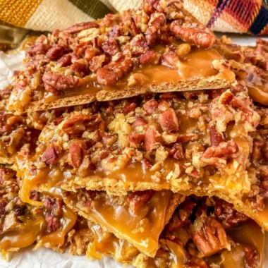 Homemade easy pecan cracker toffee on a wooden board