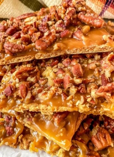 Homemade easy pecan cracker toffee on a wooden board