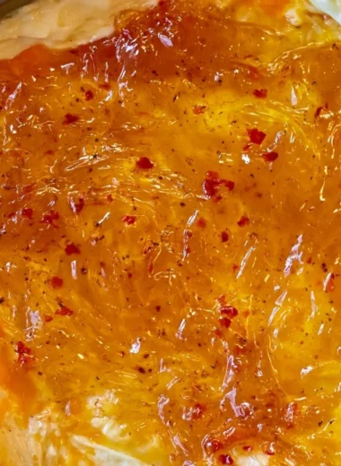Easy baked Pepper Jelly Cheese Dip served in a dish with crackers